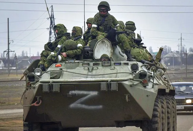 Russian soldiers on the armoured personnel carrier BTR-80 move towards mainland Ukraine on the road near Armiansk, Crimea, 25 February 2022. Russian troops entered Ukraine on 24 February prompting the country's president to declare martial law and triggering a series of announcements by Western countries to impose severe economic sanctions on Russia. (Photo by EPA/EFE/Stringer)