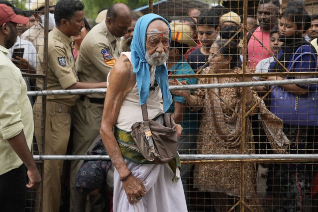 An asthma patient arrives to receive a fish therapy as others stand in a queue, in Hyderabad, India, Saturday, June 8, 2024. Every year thousands of asthma patients arrive here to receive this fish therapy from the Bathini Goud family, a secret formula of herbs, handed down by generations only to family members. The herbs are inserted in the mouth of a live sardine, or murrel fish, and slipped into the patient's throat. (Photo by Mahesh Kumar A./AP Photo)