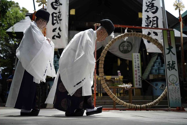 Priests perform a traditional Japanese ritual called “Chinkasai”, or a flower festival, at Namiyoke Inari shrine Friday, June 7, 2024, in Tokyo. Chinkasai is performed to protect against or ward off plagues and diseases. (Photo by Eugene Hoshiko/AP Photo)