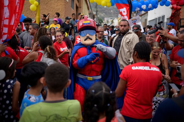 A man dressed as Venezuelan President Nicolas Maduro's character “Super Bigote” (Super Mustache) dances during a rally in Caracas on June 19, 2024. Maduro will seek his third consecutive term in office in the July 28 presidential elections. (Photo by Gabriela Oraa/AFP Photo)