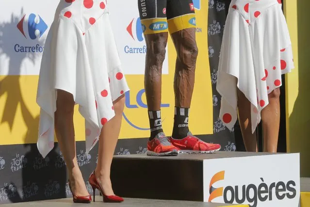 Eritrea's Daniel Teklehaimanot, wearing the best climber's dotted jersey, celebrates on the podium of the seventh stage of the Tour de France cycling race over 190.5 kilometers (118.4 miles) with start in Livarot and finish in Fougeres, France, Friday, July 10, 2015. (Photo by Christophe Ena/AP Photo)