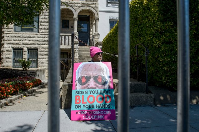 Tighe Barry sits with his sign outside of the Democratic Senatorial Campaign Committee, on Capitol Hill, and waits for the arrival of senators, Thursday, July 11, 2024, in Washington. (Photo by Rod Lamkey, Jr./AP Photo)