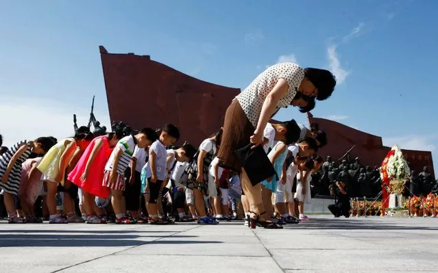 People visit Mansu Hill to pay tribute to the late leaders Kim Il Sung and Kim Jong Il on the occasion of the 25th anniversary of Kim Il Sung's death, in Pyongyang, North Korea Monday, July 8, 2019. (Photo by Jon Chol Jin/AP Photo)