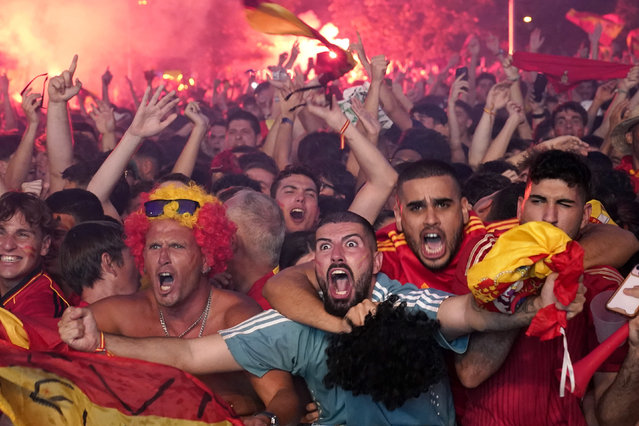 Spain supporters celebrate as Spain's Nico Williams scores the opening goal in Madrid, Spain, July 14, 2024 during the screening of the final match between Spain and England at the Euro 2024 soccer tournament in Berlin Germany. (Photo by Andrea Comas/AP Photo)