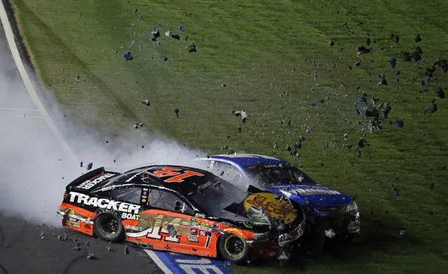 Tony Stewart (14) collides with Kasey Kahne on the front stretch during the NASCAR Sprint All-Star auto race at Charlotte Motor Speedway in Concord, N.C., Saturday, May 21, 2016. (Photo by Gerry Broome/AP Photo)