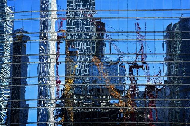 Cranes at a construction site in the Central Business District are reflected on a window panels of an office building in Beijing, Sunday, May 26, 2024. The International Monetary Fund has upgraded its forecast for China's economy, while warning that consumer-friendly reforms are needed to sustain strong, high-quality growth. (Photo by Andy Wong/AP Photo)