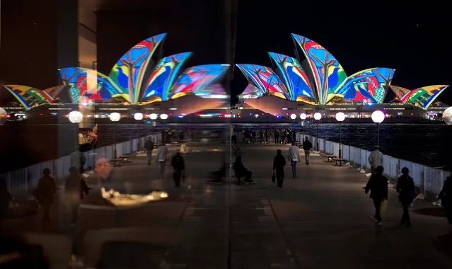 The Sydney Opera House, featuring projected art, is reflected in a hotel window during the opening night of the annual Vivid Sydney light festival in Sydney, Australia, May 27, 2016. (Photo by Jason Reed/Reuters)