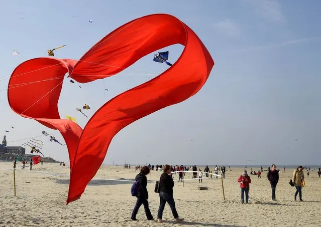 People attend the 35th International Kite Meeting of Berck-sur-Mer on April 23, 2022. (Photo by Francois Lo Presti/AFP Photo)