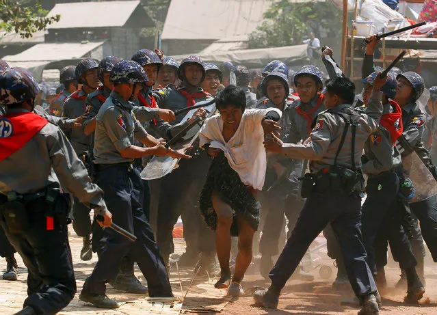 Police hit a student protester during violence in Letpadan, Myanmar, March 10, 2015. (Photo by Soe Zeya Tun/Reuters)