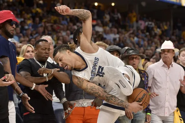Memphis Grizzlies forward Brandon Clarke (15) tries to keep the ball from going out of bounds in the second half of Game 1 in a second-round NBA basketball playoff series against the Golden State Warriors, Sunday, May 1, 2022, in Memphis, Tenn. (Photo by Brandon Dill/AP Photo)