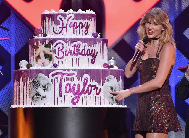 Taylor Swift poses with a giant birthday cake onstage during iHeartRadio's Z100 Jingle Ball 2019 Presented By Capital One on December 13, 2019 in New York City. (Photo by Dia Dipasupil/Getty Images for iHeartMedia)