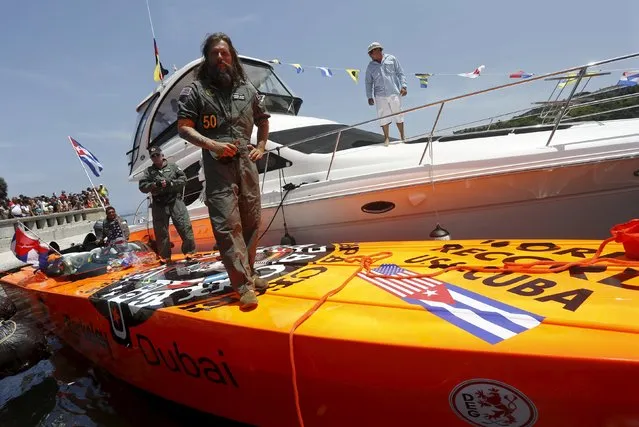 German powerboater Roger Kluh stands on his orange Apache Star speedboat after arriving in Havana from Key West in under 2 hours, setting a new speed record for an event that last took place 57 years ago, August 1, 2015. Kluh and his crew traversed the 100 miles (160 km) between Key West and Havana in about 1 hour and 45 minutes, beating the 6-hour-23-minute record set by an American in 1958. (Photo by Reuters/Stringer)