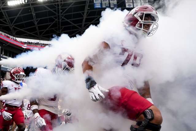 Washington State players run out onto the field before an NCAA college football game against Washington, Saturday, September 14, 2024, in Seattle. (Photo by Lindsey Wasson/AP Photo)