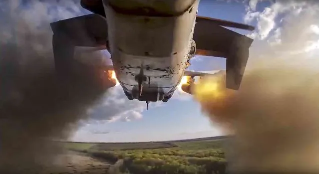 In this handout photo released by Russian Defense Ministry Press Service released on Wednesday, May 25, 2022, a Ka-52 helicopter gunship fires rockets on a mission at an undisclosed location in Ukraine. (Photo by Russian Defense Ministry Press Service via AP Photo)