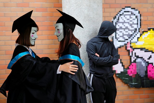 University students wearing Guy Fawkes masks pose for a photoshoot of a graduation ceremony to support anti-government protests at the Hong Kong Polytechnic University, in Hong Kong, China on October 30, 2019. (Photo by Tyrone Siu/Reuters)