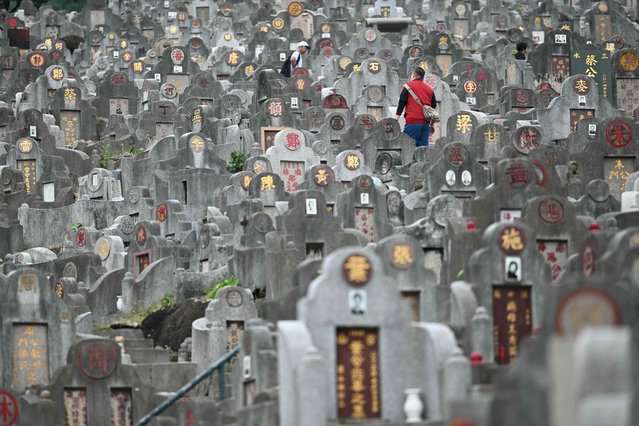 A man walks between graves at a cemetery in Hong Kong on October 11, 2024, during the Chung Yeung Festival, also known as the Double Ninth Festival, where people honour their ancestors. (Photo by Peter Parks/AFP Photo)