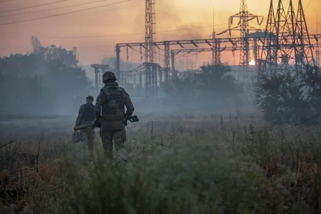 Ukrainian service members patrol an area in the city of Sievierodonetsk, as Russia's attack on Ukraine continues, Ukraine on June 20, 2022. (Photo by Oleksandr Ratushniak/Reuters)