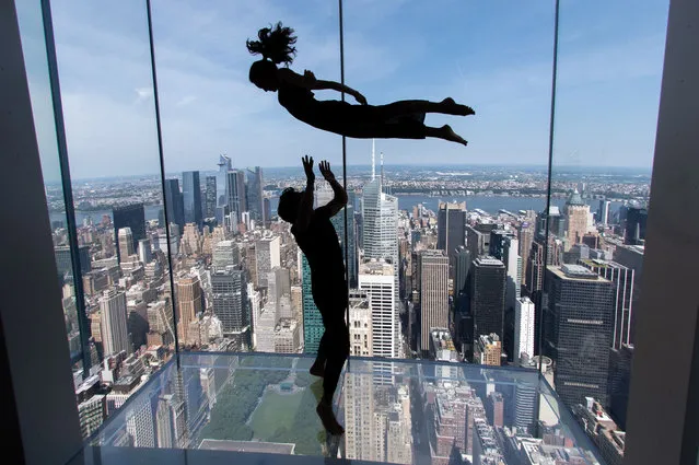 Andreas Alfaro and influencer Chelsea Yamase (Chelseakauai) perform acro-yoga poses at Summit One Vanderbilt on July 09, 2022 in New York City. (Photo by Alexi Rosenfeld/Getty Images)