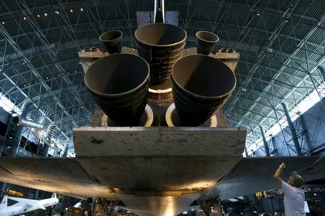 A man photographs the main engines of the space shuttle orbiter Discovery on display at the Udvar-Hazy Smithsonian National Air and Space Annex Museum in Chantilly, Virginia August 28, 2015. (Photo by Gary Cameron/Reuters)