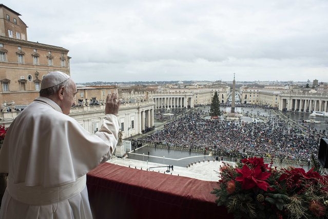 Pope Francis delivers the Urbi et Orbi (Latin for 'to the city and to the world' ) Christmas' day blessing from the main balcony of St. Peter's Basilica at the Vatican, Saturday, December 25, 2021. Pope Francis has used his Christmas Day address to pray for an end to the coronavirus pandemic. Amid a record-setting rise in COVID-19 cases in Italy this week, only a few thousand people flocked to a rain-soaked St. Peter’s Square for Francis’ annual “Urbi et Orbi” (“To the city and the world”) Christmas address on Saturday. (Photo by Vatican Media via AP Photo)