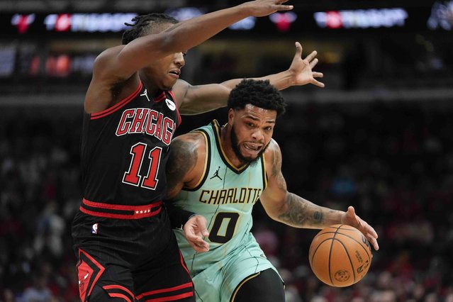 Chicago Bulls guard Ayo Dosunmu, left, guards Charlotte Hornets forward Miles Bridges during the first half of an NBA basketball game Friday, December 13, 2024, in Chicago. (Photo by Erin Hooley/AP Photo)