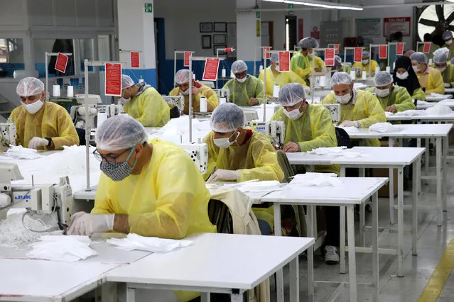 Workers, wearing face masks, produce disposable surgical gowns and masks to be used as a preventive measure against the coronavirus (COVID-19) to meet the needs of healthcare professionals who are fighting against the coronavirus (COVID-19) pandemic in Mersin, Turkey on April 18, 2020. (Photo by Salim Tas/Anadolu Agency via Getty Images)