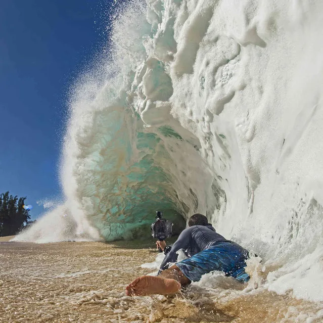 In this undated photo provided by Dane Little, Clark Little photographs waves on the North Shore of Oahu near Haleiwa, Hawaii. (Photo by Dane Little via AP Photo)