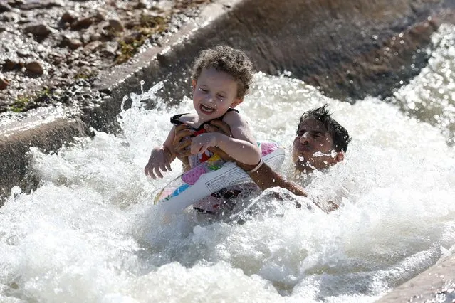 Palestinians cool off during a heat wave, in al-Oja springs near Jericho in the Israeli-Occupied West Bank July 22, 2022. (Photo by Mohamad Torokman/Reuters)