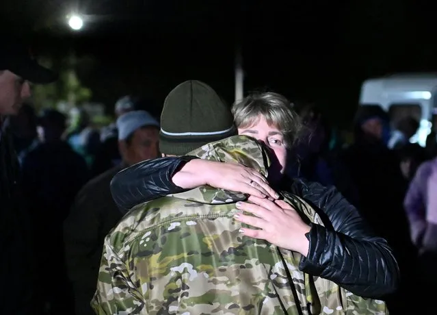 A woman bids farewell to a reservist drafted during the partial mobilisation in the Siberian settlement of Bolsherechye in the Omsk region, Russia on September 25, 2022. (Photo by Alexey Malgavko/Reuters)