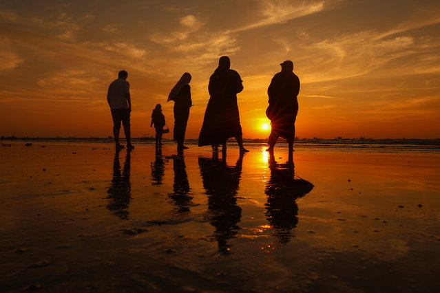People walk along Gorai Beach at sunset, in Mumbai, India, 09 December 2024. (Photo by Divyakant Solanki/EPA)