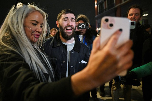 Edward “Jake” Lang, one of the defendants who was released after being pardoned, reacts while his girlfriend, Rachel Myers holds a FaceTime call with Lang’s mother outside of the DC Central Detention Facility, on January 21, 2025. (Photo by Jon Cherry/Reuters)