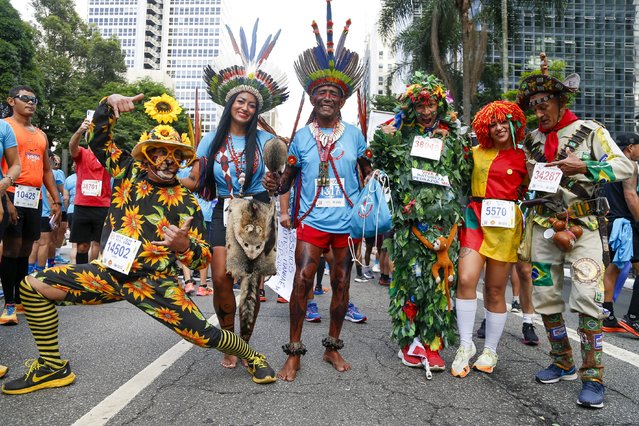 Disguised runners pose for a picture before the 98th 15-km Sao Silvestre international race in Sao Paulo, Brazil, on December 31, 2023. (Photo by Miguel Schincariol/AFP Photo)