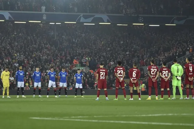Players observe a minute of silence, in the memory of the fatal victims of a stampede during a soccer match in Indonesia, before the Champions League Group A soccer match between Liverpool and Rangers at Anfield stadium in Liverpool, England, Tuesday October 4, 2022. (Photo by Rui Vieira/AP Photo)