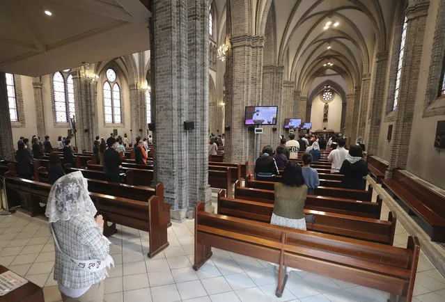 Catholics attends a mass while maintaining social distancing to help curb the spread of the coronavirus at the Myeongdong Cathedral in Seoul, South Korea, Sunday, May 17, 2020. (Photo by Lee Jung-hoon/Yonhap via AP Photo)