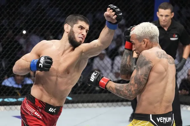 (L-R) Islam Makhachev of Russia punches Charles Oliveira of Brazil in their UFC lightweight championship fight during the UFC 280 event at Etihad Arena on October 22, 2022 in Abu Dhabi, United Arab Emirates. (Photo by Chris Unger/Zuffa LLC)