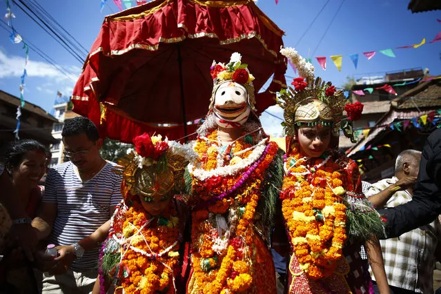 Nepalese devotees gather as people dressed as deities take part in a procession to celebrate the festival of Deity Narsingh in Lalitpur, Nepal on August 23, 2016. (Photo by Skanda Gautam/ZUMA Press/Splash News)