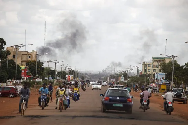 Smoke rises from burning barricades in Ouagadougou, Burkina Faso, September 19, 2015. (Photo by Joe Penney/Reuters)