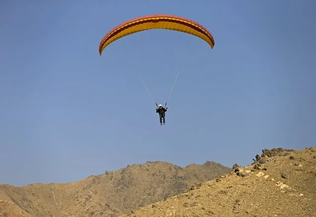 Afghan paraglider Hussain, 31, is pictured in the air in Kabul, Afghanistan September 16, 2015. A group of young Afghans are taking to the skies of a capital where military helicopters and surveillance balloons are a far more familiar sight. Paragliding is an expensive pastime, however, in a city where the average wage is about $200 a month. (Photo by Mohammad Ismail/Reuters)