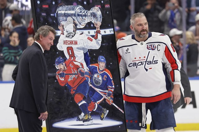 Washington Capitals left wing Alex Ovechkin (8), right, poses for a photo with Wayne Gretzky during a ceremony after he scored his 895th career goal during the second period of an NHL hockey game against New York Islanders in Elmont, N.Y., Sunday, April 6, 2025. (Photo by Adam Hunger/AP Photo)