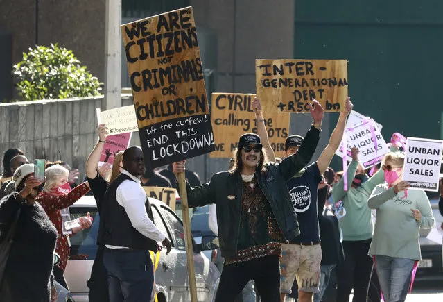 Demonstrators working in the hospitality industry protest against lockdown regulations in the streets close to Parliament in Cape Town, South Africa, Friday July 24, 2020. People from various hospitality or restaurant establishments marched on parliament to raise awareness about the industry's declining revenues amid the Covid-19 lockdown. (Photo by Nardus Engelbrecht/AP Photo)