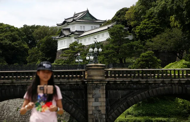 A visitor takes a selfie at the Imperial Palace before Emperor Akihito makes a rare video address to the public, in Tokyo, Japan, August 8, 2016. (Photo by Kim Kyung-Hoon/Reuters)