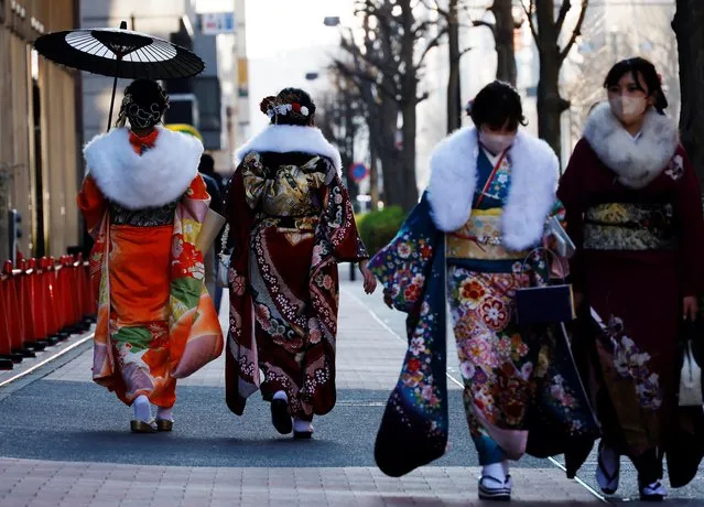 Kimono-clad young women walk outside a venue during their Coming of Age Day celebration ceremony in Yokohama, Japan on January 9, 2023. (Photo by Kim Kyung-Hoon/Reuters)