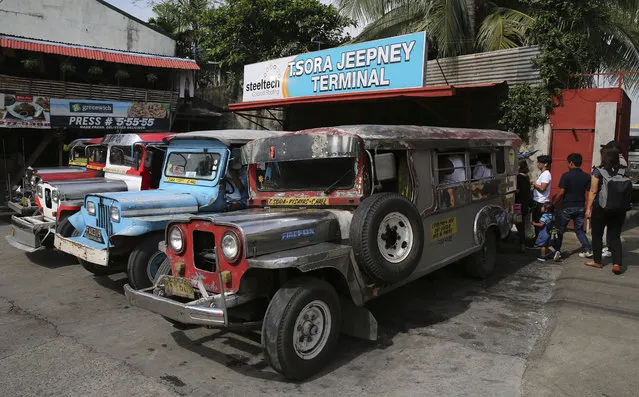 In this September 26, 2017, photo, passengers board jeepneys at a terminal in Manila, Philippines. (Photo by Aaron Favila/AP Photo)