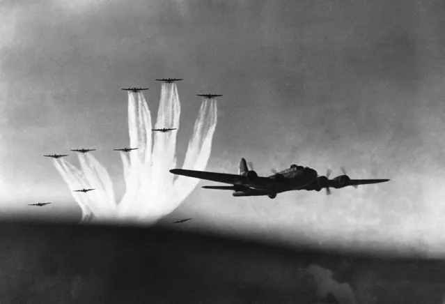 Flying fortresses, flying at high altitude in a practice bombing raid over England leave vapor trails in the sky, on January 4, 1943. (Photo by AP Photo)