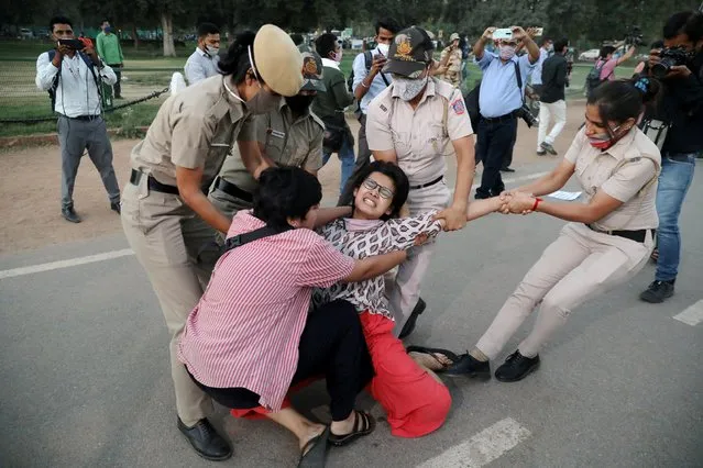 A demonstrator is detained by police during a protest after the death of a rape victim, on Rajpath near India Gate, in New Delhi, India, September 30, 2020. (Photo by Anushree Fadnavis/Reuters)