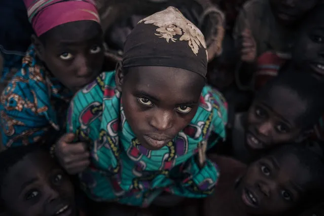 Displaced girls and boys from the Bafuliru community pose for a photograph in the internally displaced persons (IDP) camp of Bijombo, South Kivu Province, eastern Democratic Republic of Congo, on October 9, 2020. Since February 2019, the landlocked highlands of Fizi and Uvira in South Kivu have been the scene of clashes and retaliation attacks by armed groups claiming to defend the interests of their respective communities. According to the United Nations High Commissioner for Human Rights, approximately one hundred villages have been destroyed and burned, several dozen civilians have been killed and thousands of people have been forced to flee their homes. (Photo by Alexis Huguet/AFP Photo)