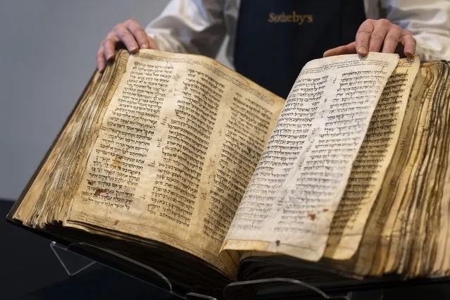 Sotheby's unveils the Codex Sassoon for auction, Wednesday, February 15, 2023, in the Manhattan borough of New York. The auction house is billing the lot as the “earliest, most complete Hebrew Bible ever discovered”. (Photo by John Minchillo/AP Photo)