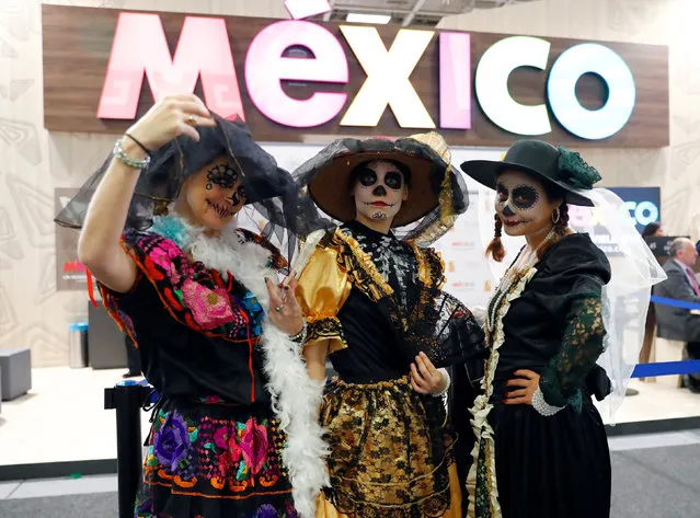Exhibitors pose at the Mexico booth at the International Tourism Trade Fair ITB in Berlin, Germany on March 7, 2018. (Photo by Fabrizio Bensch/Reuters)