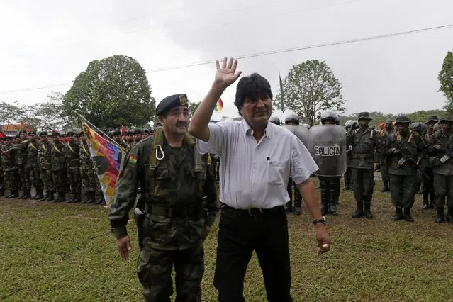 Bolivia's President Evo Morales (C) waves as he reviews troops in Chimore, east of La Paz, December 10, 2014. (Photo by David Mercado/Reuters)