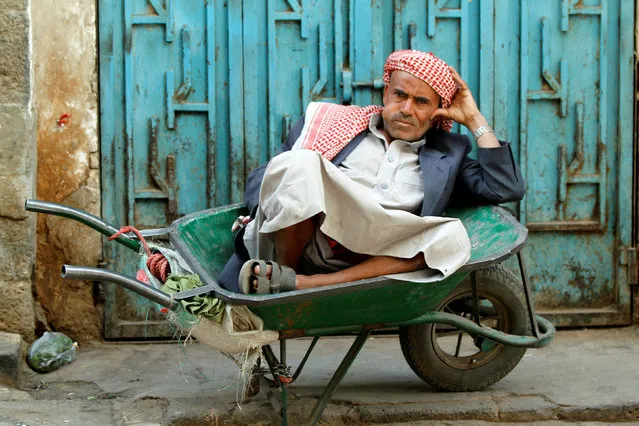 A man rests as he chews Qat, in the old market at the Historic City of Sanaa, Yemen March 23, 2018. (Photo by Mohamed al-Sayaghi/Reuters)